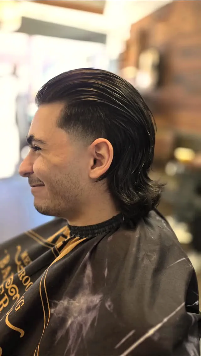 A slicked-back modern cut finished at Dapper Chaps