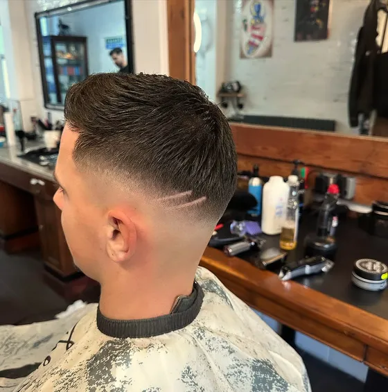 A clean skin fade with a shaved design line, finished at Dapper Chaps