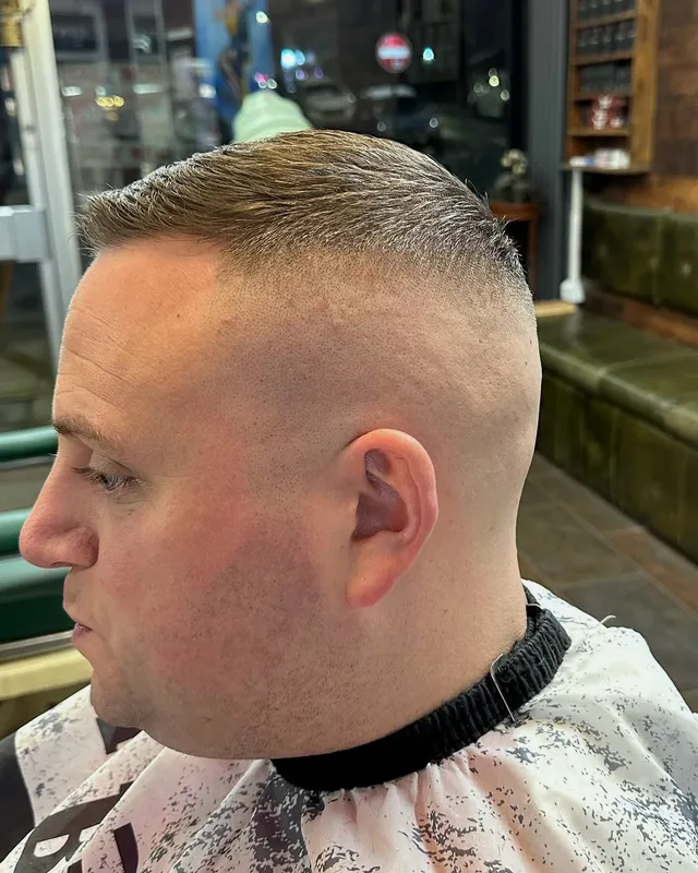 A copper beard and curly fade finished at Dapper Chaps